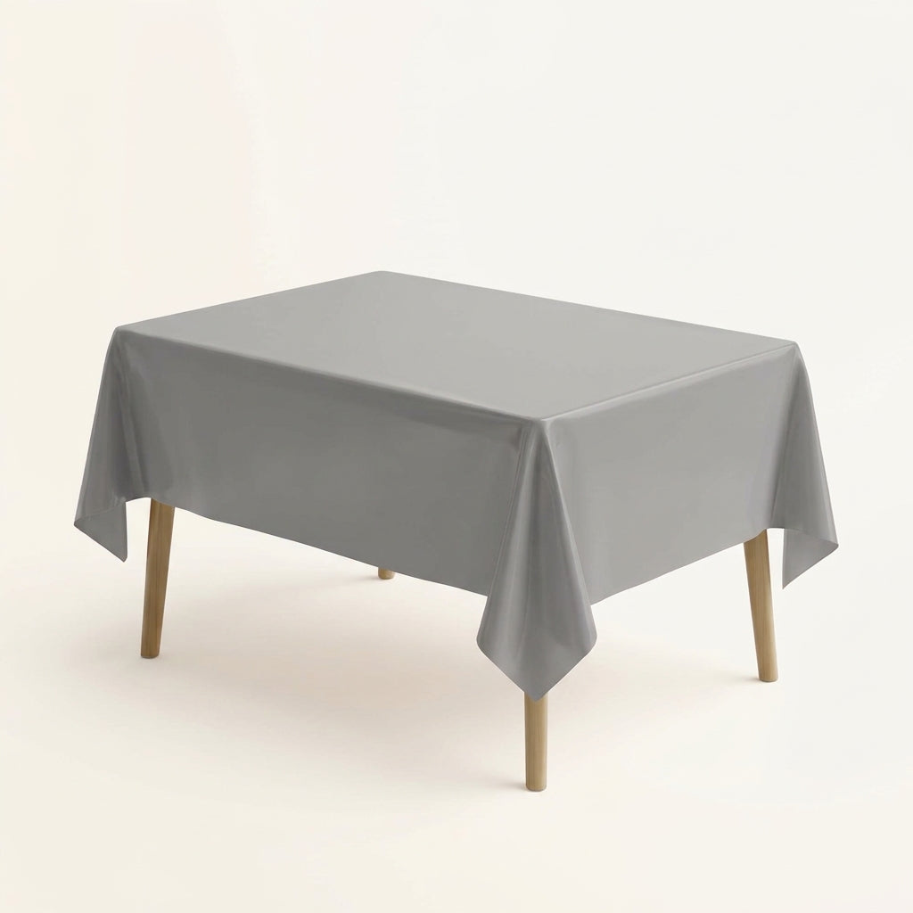 Grey plastic party table cover on a rectangular table against a plain background